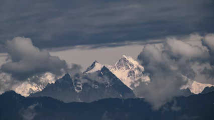 Fotobehang Kangchenjunga Mount kangchenjunga peak of Himalayan mountains at dawn. Snow clad white peaks under cloud cover as seen fro kalimpong india.