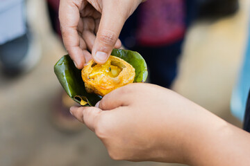 Phuchka or Pani Puri served on a bowl made of shal leaves in india. This popular street food is...