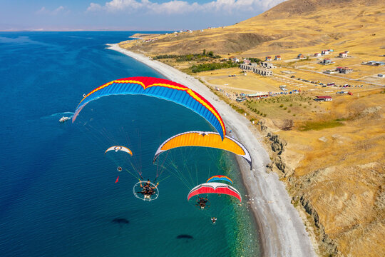 Aerial view of paramotors flying in formation at Van Lake coastline, Van, Turkey.