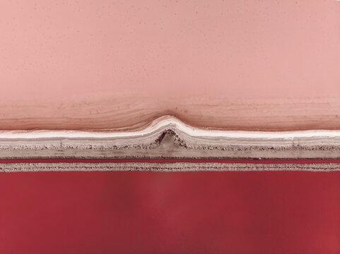 Aerial view of the pink salt lake Hutt Lagoon with different colours of red and pink due to an algea in the water, Port Gregory, Western Australia.