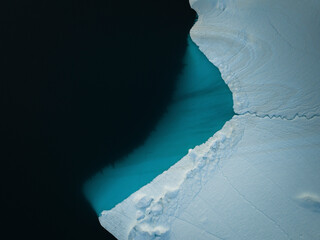 Aerial top-down drone view of an iceberg landscape structure at Ilulissat ice fjord, Greenland, Arctic.