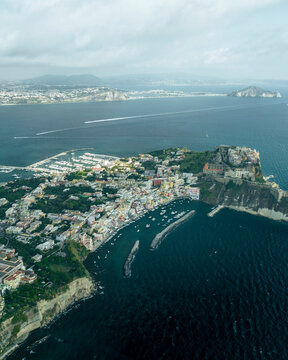 Aerial view of Procida Old town with a small harbour on Procida Island with the Gulf of Naples in background, Flegree Islands archipelagos, Naples, Campania, Italy.