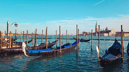 Fototapeta na wymiar Beautiful seascape with gondolas on the blue sea water in Venice
