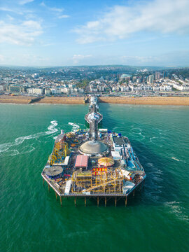Aerial view of Brighton Palace Pier along the coastline facing the English Channel in Brighton, England, United Kingdom.