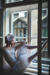 Beautiful balerina looking trough window © Aleksandar