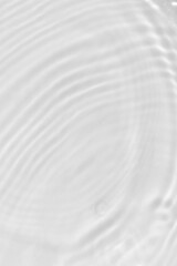 Defocus blurred transparent white colored clear calm water surface texture with splashes reflection. Trendy abstract nature background. Water waves in sunlight with copy space. Blue watercolor shine.