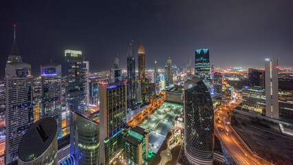 Skyline view of the high-rise buildings on Sheikh Zayed Road in Dubai aerial all night timelapse,...