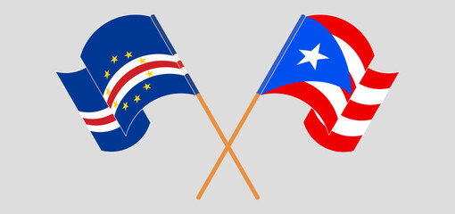 Crossed and waving flags of Cape Verde and Puerto Rico