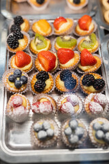 Lots of fresh pastries and desserts on the bakery and store counter - craft sweets