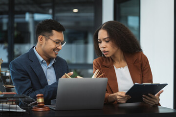 Teamwork of business lawyer meeting working hard about legal legislation in courtroom to help their customer.