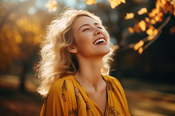 A blonde woman breathes calmly looking up enjoying autumn air