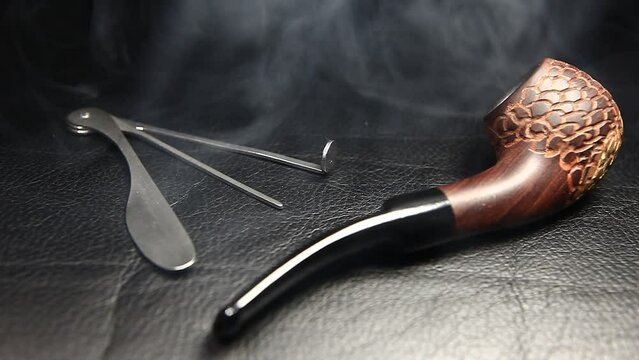 footage of smoking pipe leather background