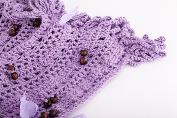 Knitted scarf made from violet yarn.