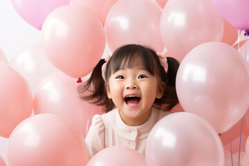 Fototapeta na wymiar Happy asian little girl excited looking up in the balloons