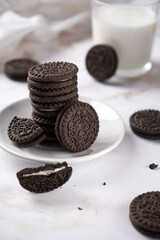 Pile of Delicious Chocolate Chip Cookies on a White Plate with Milk Bottles