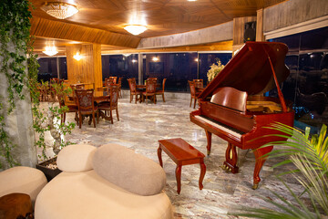 Interior of cozy restaurant with panoramic windows. Tables for four guests