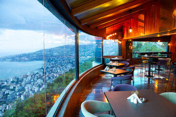 Interior of cozy restaurant with panoramic windows