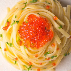 Spaghetti pasta with red caviar close up, square crop.  Delicatessen seafood pasta