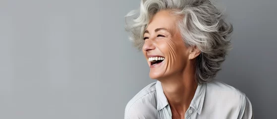 Foto op Plexiglas Beautiful gorgeous 50s mid age beautiful elderly senior model woman with grey hair laughing and smiling. Mature old lady close up portrait. Healthy face skin care beauty, skincare cosmetics, dental © DZMITRY