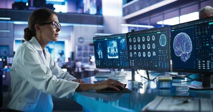 Medical Hospital Research Laboratory: Caucasian Female Neurosurgeon Using Computer with Brain Scan MRI Images, Finding Best Treatment for Sick Patient. Health Care Neurologist Analysing MRI Scan.
