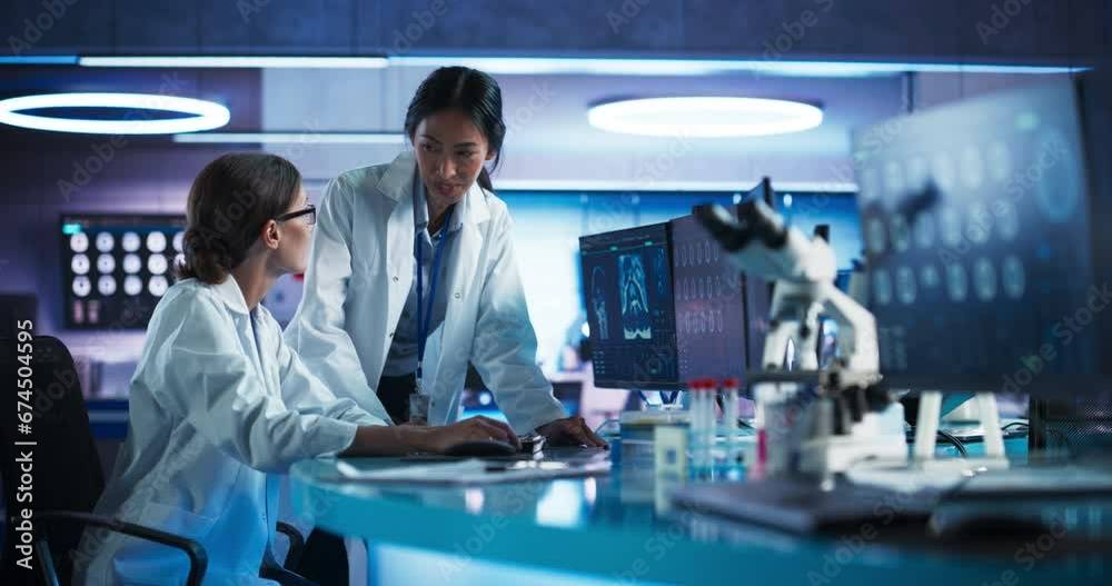 Poster Medical Hospital Research Laboratory: Caucasian And Asian Female Scientists Talking And Using Desktop Computer With CT Scans Of Human Brain. Surgeon And Neurologist Discussing Brain Damage Treatment.