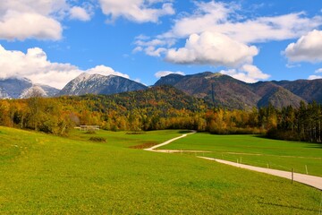 Road leadong acorss a pasture at Stefanja Gora with Krvavec and Kalski Greben mountains in...