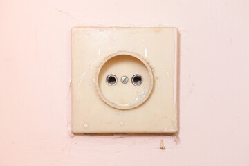 Old electrical socket. Power outlet vintage. Grunge abandoned home texture. Antique socket....