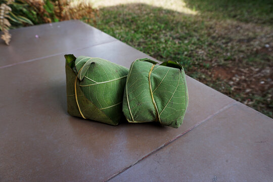 Sego Berkat, a traditional food dish from Central Java, Indonesia, consists of rice and side dishes, wrapped in teak leaves