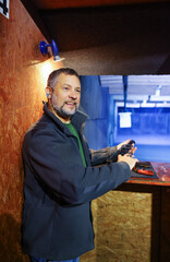 Man with pistol at firing range 