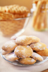 Cookies on a plate. Selective focus. Photo of a delicious dessert with powdered sugar, food. Sweets in the background in blur.