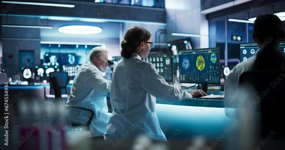 Aufkleber Back View Of Diverse Scientists Working In Medical Research Center. Male Doctor Using Microscope And His Female Colleagues Looking At MRI Brain Scans On Desktop Computers. Biotechnology Lab Concept.