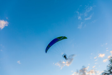 Paragliding in the sky. Tandem paraglider flying over Tiradentes Minas Gerais city and mountains in bright sunny day.