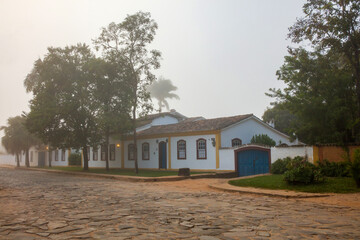 Fototapeta na wymiar Fog apparent on the stone streets and colonial houses in the historic city of Tiradentes, Minas Gerais, Brazil.