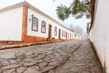 Fog apparent on the stone streets and colonial houses in the historic city of Tiradentes, Minas Gerais, Brazil.