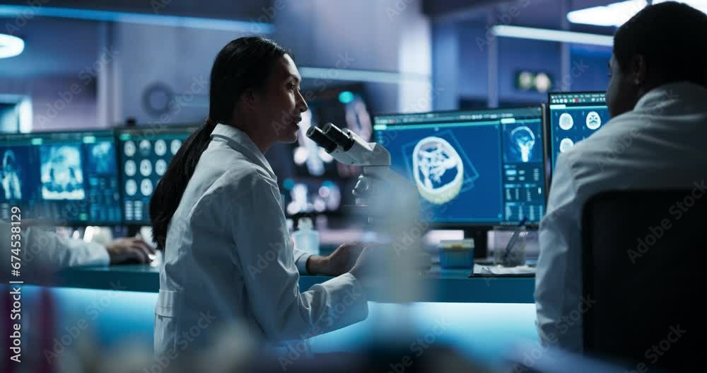 Poster female asian neuroscientist using microscope and discussing finding with black doctor in medical res