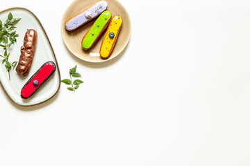 Set of eclairs cakes with different flavors. Sweet food background