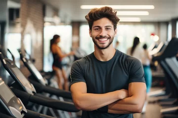 Tuinposter portrait of young muscular man resting in gym while looking at camera. Healthy lifestyle © zamuruev