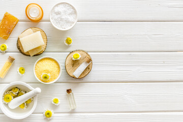 Herbal organic cosmetics products with chamomile flowers, top view