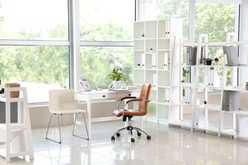 Interior of modern medical office with doctor's workplace and window