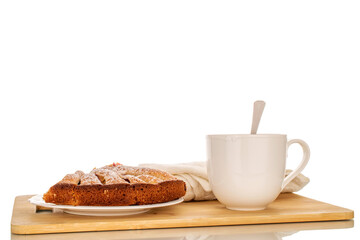 Sweet homemade plum cake on white ceramic saucer with cup on wooden kitchen board, macro, isolated on white background.