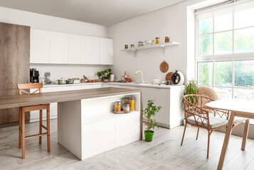 Interior of light kitchen with modern coffee machines