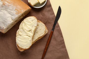 Tasty bread with butter on beige background