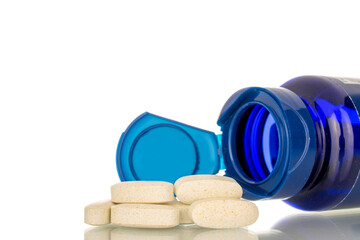 Several medical pills with plastic container, macro, isolated on white background.