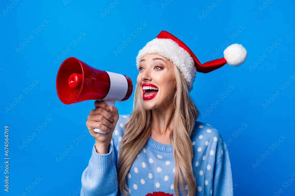 Canvas Prints Photo portrait of pretty blonde young girl scream megaphone dressed sweater x-mas hat isolated on blue color background