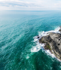Fototapeta na wymiar Centro, ES, Brazil Aerial Shot of Waves Crashing the Coastal Rocks