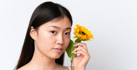 Young Chinese woman isolated on white background holding a sunflower. Close up portrait