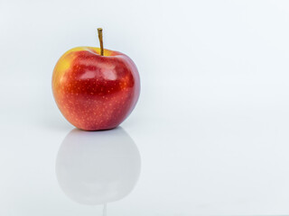 Red ripe apple isolated on white background with reflection
