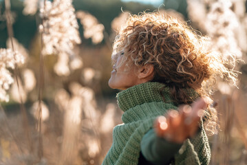 Happy healthy free woman outstretching arms in outdoor leisure activity alone kissed by golden sun sunlight sunset light. People loving nature and life. Joyful lifestyle. Travel. Wellbeing concept © simona