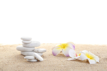 Obraz na płótnie Canvas Zen stones and flowers on the sand isolated on white background