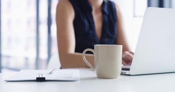 Mug, coffee and business woman at laptop in office for planning project, typing email and information. Closeup, employee and working at computer with steam of caffeine, drink and cappuccino on desk